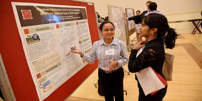 A young scholar explaining data charts to peers